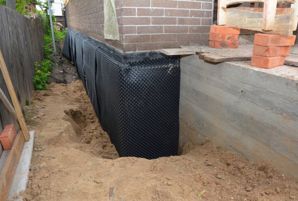SJ Waterproofing Pros technician performing targeted Waterproofing assessment in Robbins, NC